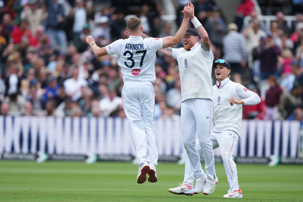 England's Gus Atkinson, left, celebrates with captain Ben Stokes after bowling out New Zealand's Matt Henry to win the Test match between England and New Zealand at Lord's cricket ground in London, Sunday, June 7, 2026. (AP Photo/Kirsty Wigglesworth)