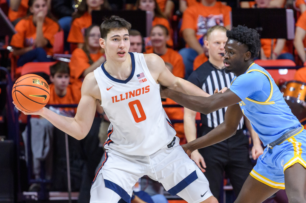 Illinois forward David Mirkovic looks to pass as DaMariee Jones defends during an NCAA college basketball game against Southern University Monday, Dec. 29, 2025, in Champaign, Ill. (AP Photo/Craig Pessman)