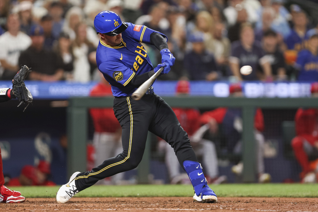 Seattle Mariners' Mitch Garver hits a home run against the Los Angeles Angels during seventh inning of a baseball game Friday, Sept. 12, 2025, in Seattle. (AP Photo/Kevin Ng)