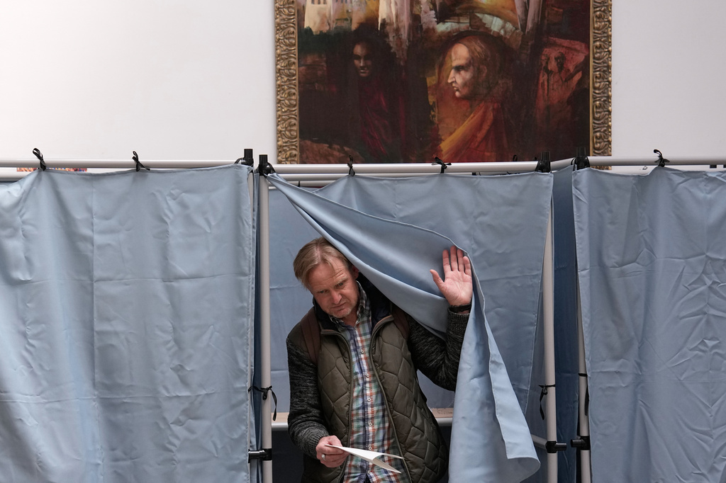 A man prepares to cast his ballot at a polling station in Budapest, Hungary, Sunday, April 12, 2026. (AP Photo/Petr David Josek)
