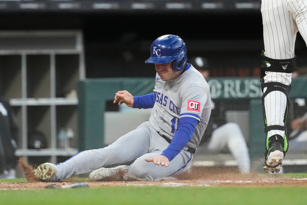 Kansas City Royals' Lane Thomas, center, scores on a two-run single by Vinnie Pasquantino as Chicago White Sox catcher Drew Romo catches the ball during the fourth inning of a baseball game in Chicago, Wednesday, May 13, 2026. (AP Photo/Nam Y. Huh)