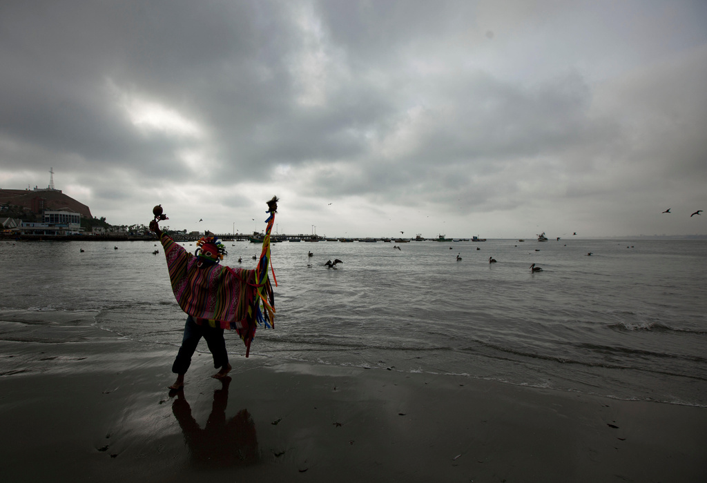 FILE - A Peruvian shaman perform a ritual against the alleged 2012 apocalyptic Mayan prediction in Lima, Peru, Thursday, Dec. 20, 2012. (AP Photo/Martin Mejia, file)