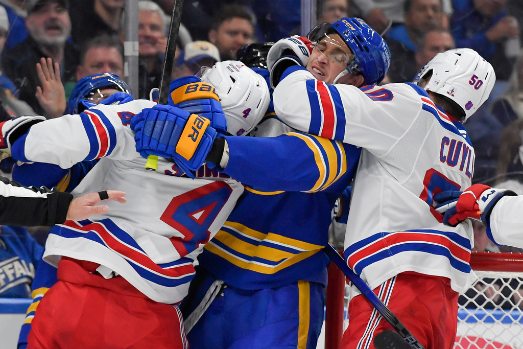 Buffalo Sabres center Tage Thompson, second from right, is held by New York Rangers left wing Will Cuylle (50) as players scuffle after the whistle during the second period of an NHL hockey game in Buffalo, N.Y., Thursday, Oct. 9, 2025. (AP Photo/Adrian Kraus)