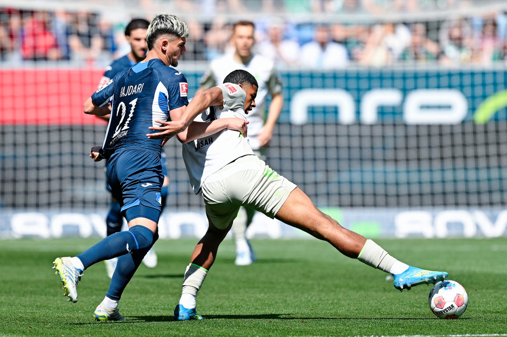 Hoffenheim's Albian Hajdari, left, and Bremen's Salim Musah fight for the ball, during the German Bundesliga soccer match between TSG 1989 Hoffenheim and Werder Bremen, in Sinsheim, Germany, Saturday, May 9, 2026. (Uwe Anspach/dpa via AP)