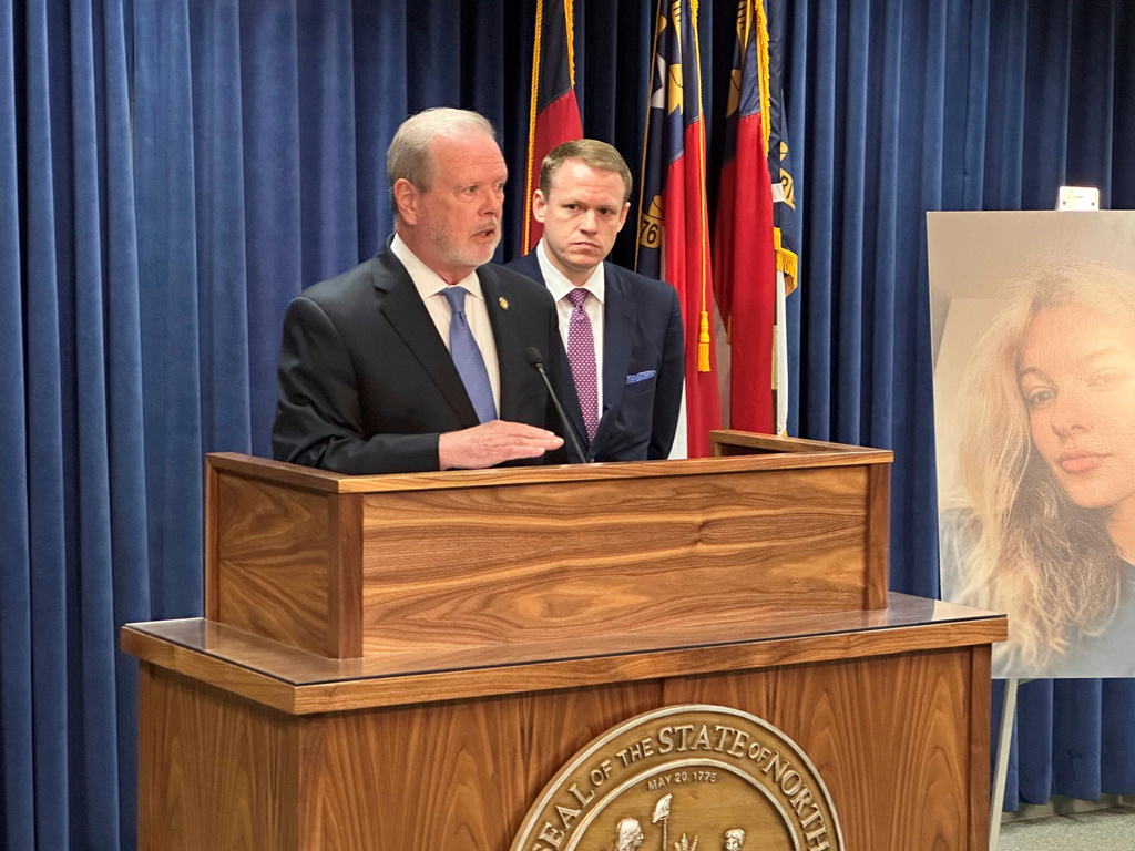 North Carolina state Senate leader Phil Berger, R-Rockingham, left, speaks while House Speaker Destin Hall, R-Caldwell, listens and stands next to a photo of commuter train stabbing victim Iryna Zarutska, during a Legislative Building news conference, in Raleigh, N.C., Thursday, Sept. 11, 2025. (AP Photo/Gary D. Robertson)