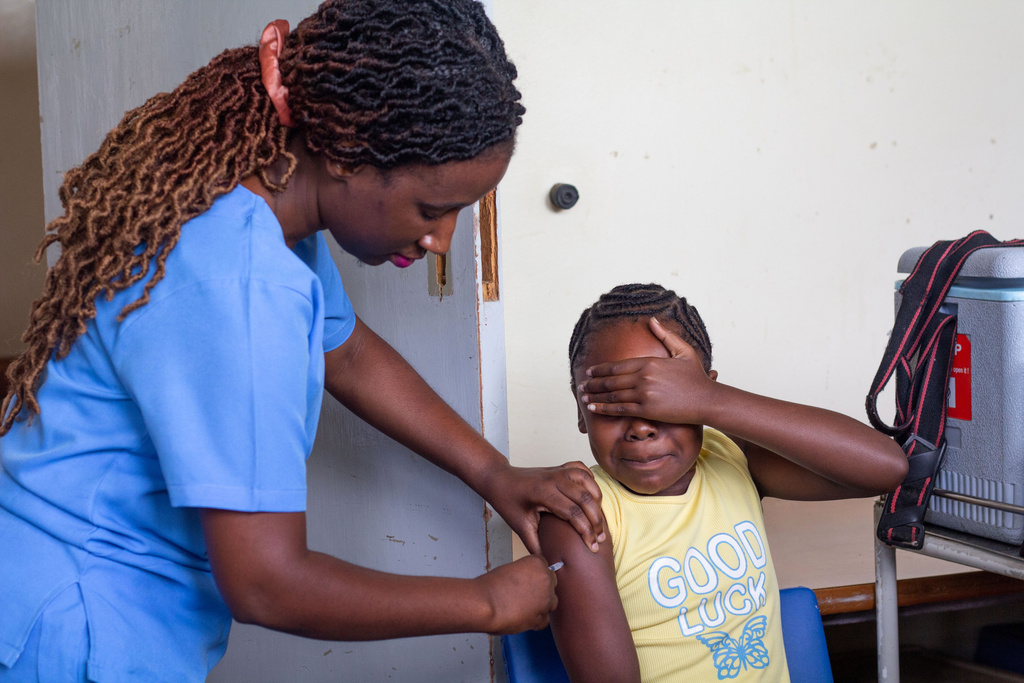 A 10-year-old girl reacts after receiving a free dose of the HPV vaccine at Budiriro Polyclinic in Harare, Zimbabwe, Saturday, Jan. 17, 2026. (AP Photo/Aaron Ufumeli)