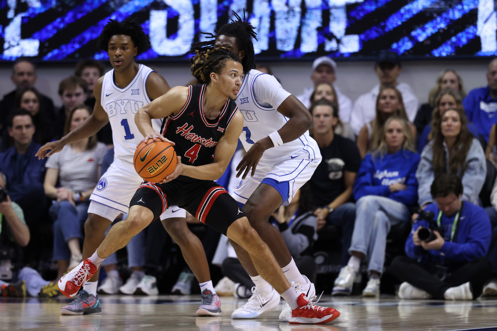 Houston guard Kingston Flemings (4) looks for the play against BYU during the first half of an NCAA college basketball game, Saturday, Feb. 7, 2026, in Provo, Utah. (AP Photo/Rob Gray)