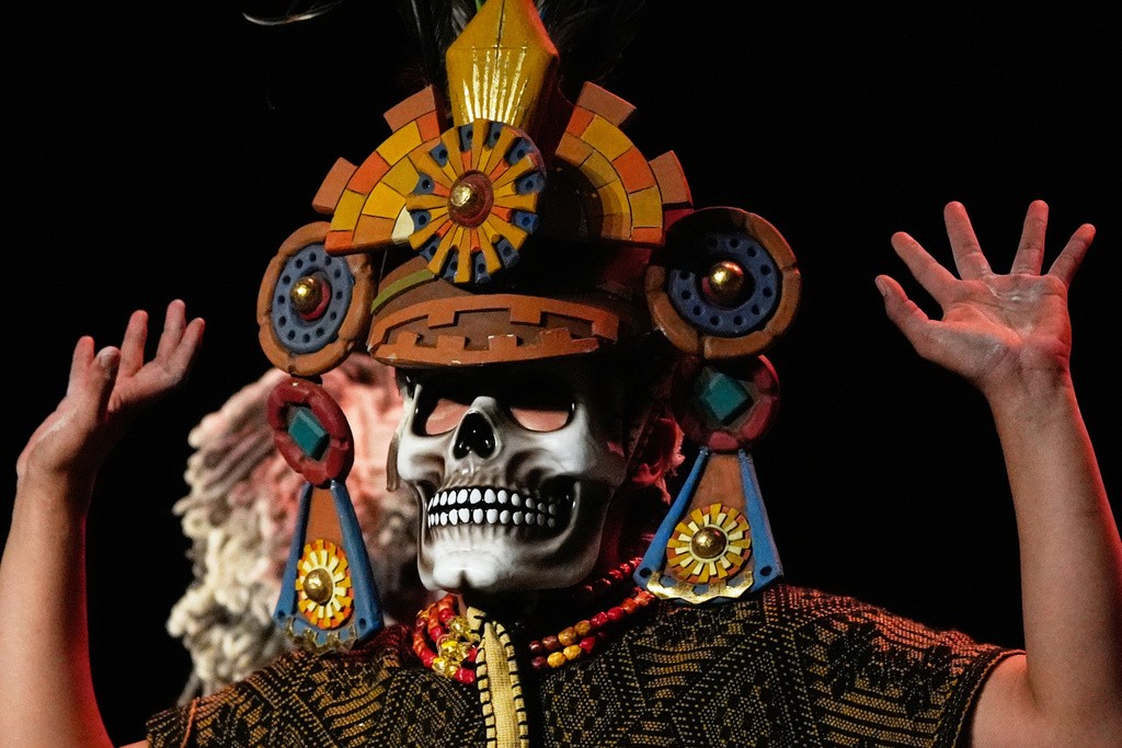 An acrobat from a Mexican theater company performs the show titled "Mortal Leap into Xibalba," which reinterprets a myth from a sacred Mayan book about creation and the journey to the underworld, in Mexico City, Saturday, Nov. 22, 2025. (AP Photo/Marco Ugarte)