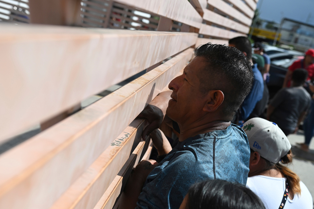 Relatives of crew members of the boat Maria Candelaria peer through a fence outside a police facility in Manta, Ecuador, Monday, Sept. 7, 2026, as they wait for the crew to return after the boat was intercepted by U.S. authorities on suspicion of alleged drug trafficking. (AP Photo/Ariel Ochoa)