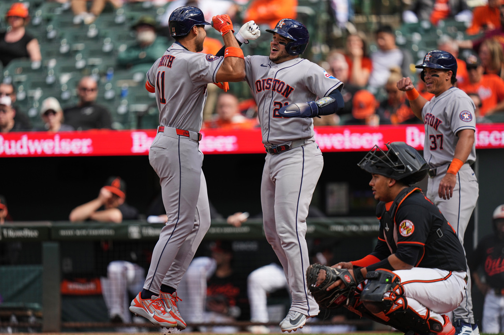 Houston Astros' Cam Smith (11) celebrates with Yainer Diaz (21) after hitting a three-run home run during the first inning in the second baseball game of a doubleheader against the Baltimore Orioles, Thursday, April 30, 2026, in Baltimore. (AP Photo/Stephanie Scarbrough)
