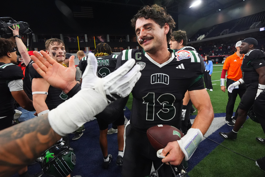 Ohio quarterback Parker Navarro (13) is congratulated after winning the Frisco Bowl NCAA college football game against UNLV Tuesday, Dec. 23, 2025, in Frisco, Texas. (AP Photo/LM Otero)