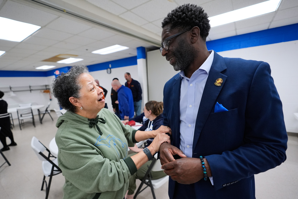 Chedrick Greene, Democratic candidate for the 35th Senate District, speaks with Juanita Foxx at a rally Monday, April 27, 2026, in Saginaw, Mich. (AP Photo/Paul Sancya)