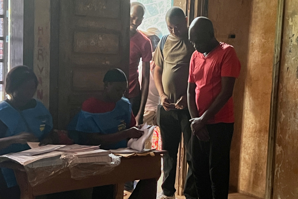 Voters queue at a polling station to cast their ballot in the presidential election in Bangui, Central African Republic, Sunday, Dec. 28, 2025. (AP Photo/Jean-Fernand Koena)