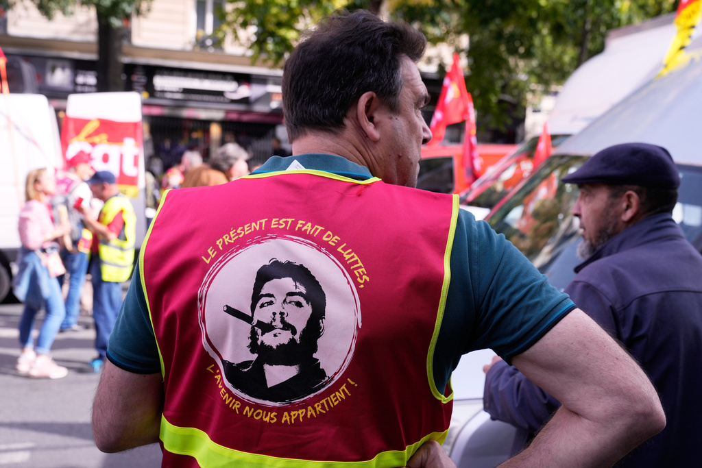 A demonstrator wears a shirt printed with a Che Guevara during a new round of strikes and protests against the caretaker government and cost-cutting Thursday, Oct. 2, 2025 in Paris. (AP Photo/Michel Euler)