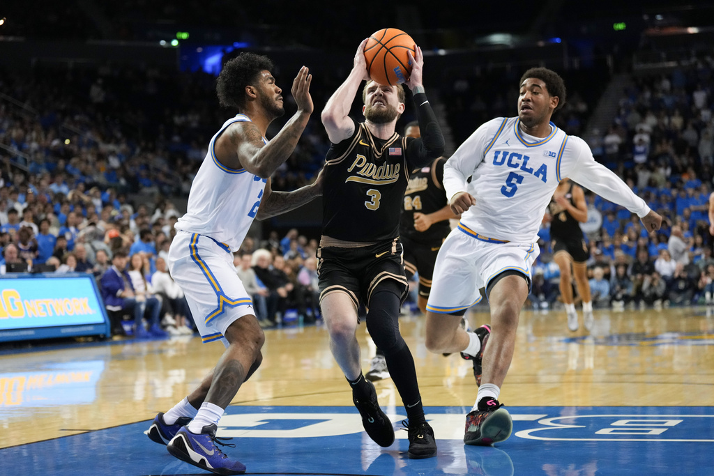 UCLA guard Donovan Dent (2) pressures Purdue guard Braden Smith (3) during the first half of an NCAA college basketball game in Los Angeles, Tuesday, Jan. 20, 2026. (AP Photo/Jae C. Hong)