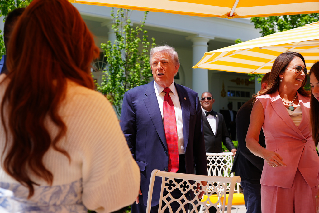 President Donald Trump greets guests, including Agriculture Secretary Brooke Rollins, right, at a luncheon for mothers Friday, May 8, 2026, in the Rose Garden of the White House in Washington. (AP Photo/Jacquelyn Martin)