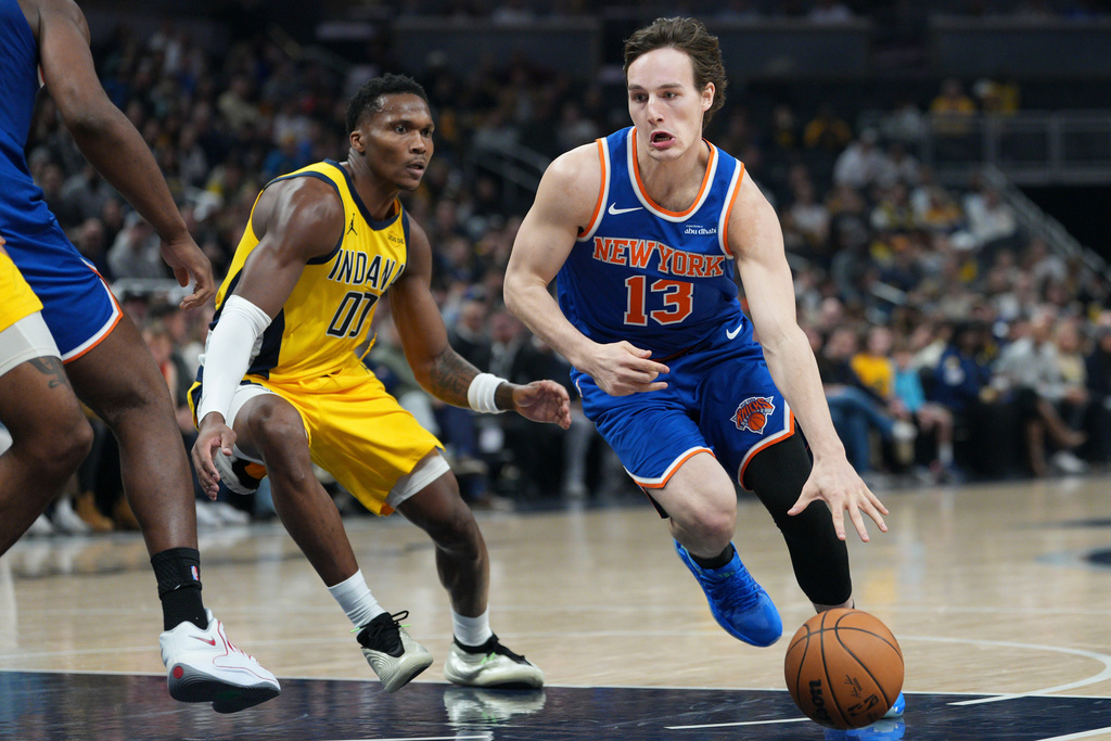 New York Knicks guard Tyler Kolek (13) goes around Indiana Pacers guard Bennedict Mathurin (00) during the first half of an NBA basketball game in Indianapolis, Thursday, Dec. 18, 2025. (AP Photo/AJ Mast)