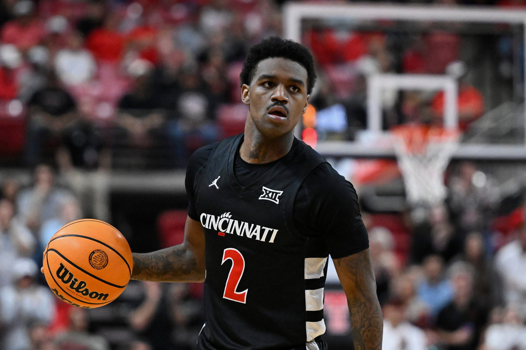 FILE - Cincinnati guard Jizzle James (2) brings the ball up court against Texas Tech during the second half of an NCAA college basketball game on Feb. 24, 2026, in Lubbock, Texas. (AP Photo/Justin Rex, File)