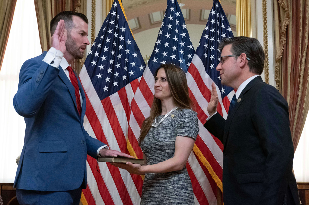 Speaker of the House Mike Johnson, R-La., right, administers the House oath of office to Rep. Clay Fuller, R-Ga., during a ceremonial swearing-in on Capitol Hill in Washington, Tuesday, April 14, 2026. Kate Fuller holds the Bible.( AP Photo/Jose Luis Magana)