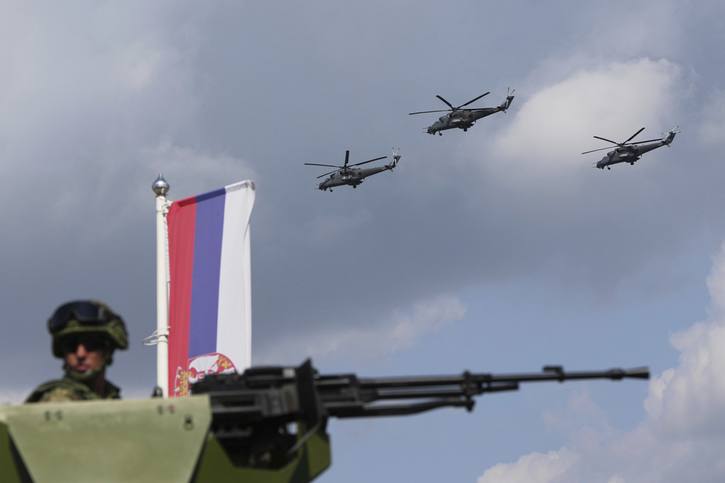 Serbian army helicopters MI-35 fly over the city ahead of a military parade scheduled for Sept. 20 in the Serbian capital Belgrade, Friday, Sept. 12, 2025. (AP Photo/Darko Vojinovic)