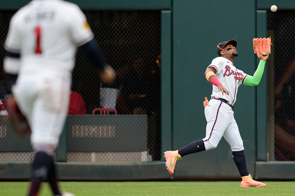 Atlanta Braves right fielder Ronald Acuña Jr. (13) makes the catch against Kansas City Royals catcher Salvador Perez in the second inning of a baseball game, Sunday, March 29, 2026, in Atlanta. (AP Photo/Mike Stewart)