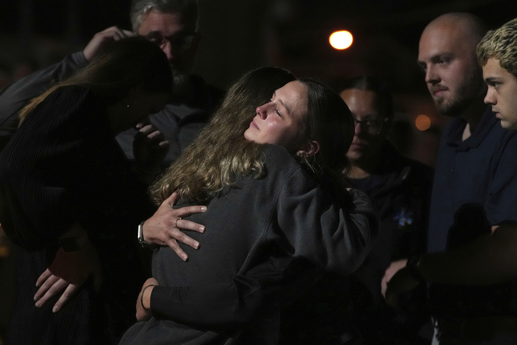 Attendees share a hug during a vigil at Spring Grove Alliance church Thursday, Sept. 18, 2025, in Spring Grove, Pa., after multiple police officers were shot and killed. (AP Photo/Matt Slocum)