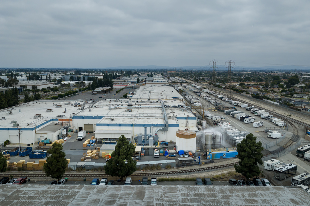 Water is sprayed on a damaged tank at GKN Aerospace in Garden Grove, Calif., on Sunday, May 24, 2026, after the tank containing a chemical used to make plastic parts overheated Thursday. (AP Photo/Ethan Swope)
