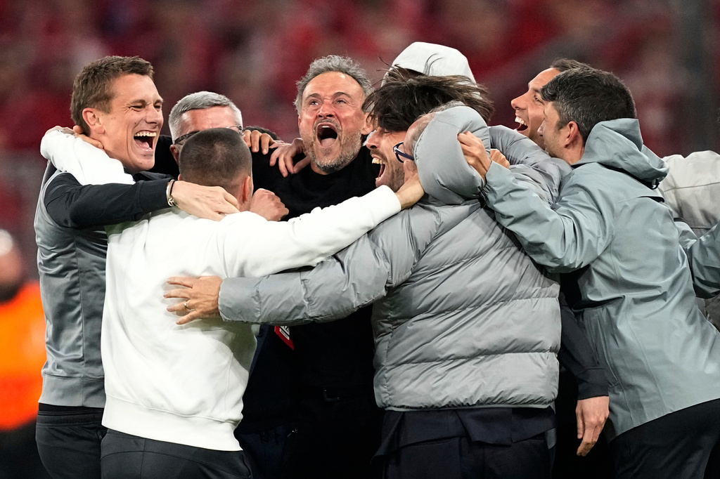 PSG's head coach Luis Enrique, center, celebrates with the other members of the team after the Champions League semifinal second leg soccer match between Bayern Munich and Paris Saint Germain in Munich, Germany, Wednesday, May 6, 2026. (AP Photo/Martin Meissner)