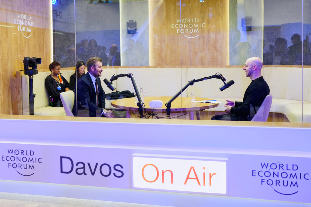 Former soccer player David Beckham, left, speaks with American popular science author Adam Grant, right, in a podcast booth during of the Annual Meeting of the World Economic Forum in Davos, Switzerland, Tuesday, Jan. 20, 2026. (AP Photo/Markus Schreiber)