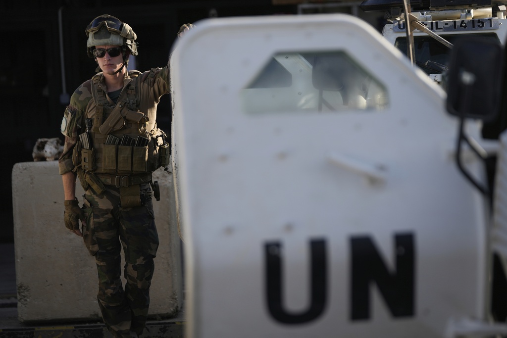 A French U.N. peacekeeper stands beside an armored vehicle at his base, waiting to move with his unit for a patrol along the Lebanese-Israeli border in Deir Kifa, southern Lebanon, Wednesday, Aug. 20, 2025. (AP Photo/Hussein Malla)