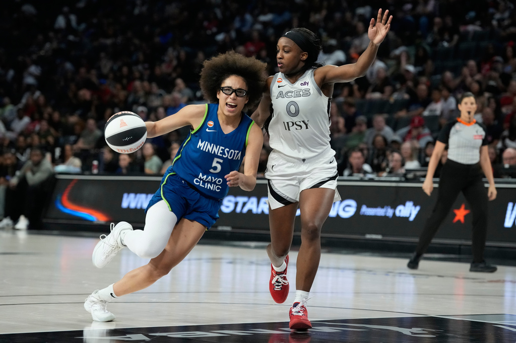 Minnesota Lynx guard Olivia Miles (5) drives against Las Vegas Aces guard Jackie Young (0) during the second half of a WNBA basketball game Saturday, June 13, 2026, in Las Vegas. (AP Photo/John Locher)