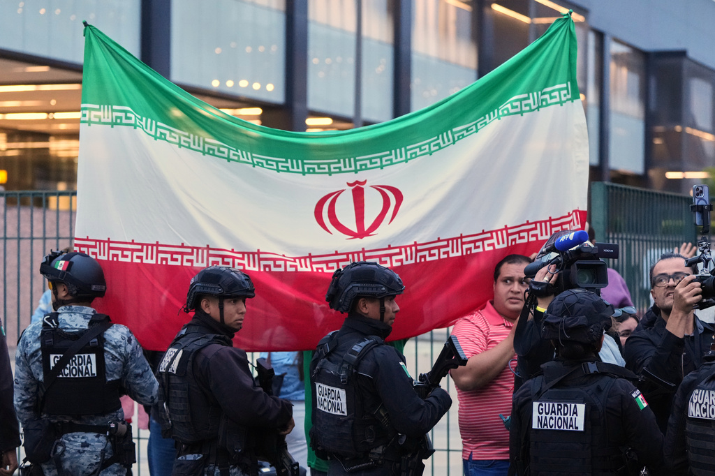 Fans for team Iran wave as players arrive for the World Cup soccer tournament in Tijuana, Mexico, Sunday, June 7, 2026. (AP Photo/Gregory Bull)