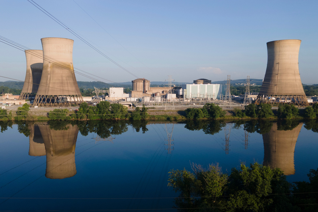 FILE - At Constellation's nuclear power plant on Three Mile Island, called the Crane Clean Energy Center, near Middletown, Pa., the cooling towers are reflected in the Susquehanna River at sunrise, June 25, 2025. (AP Photo/Ted Shaffrey, File)