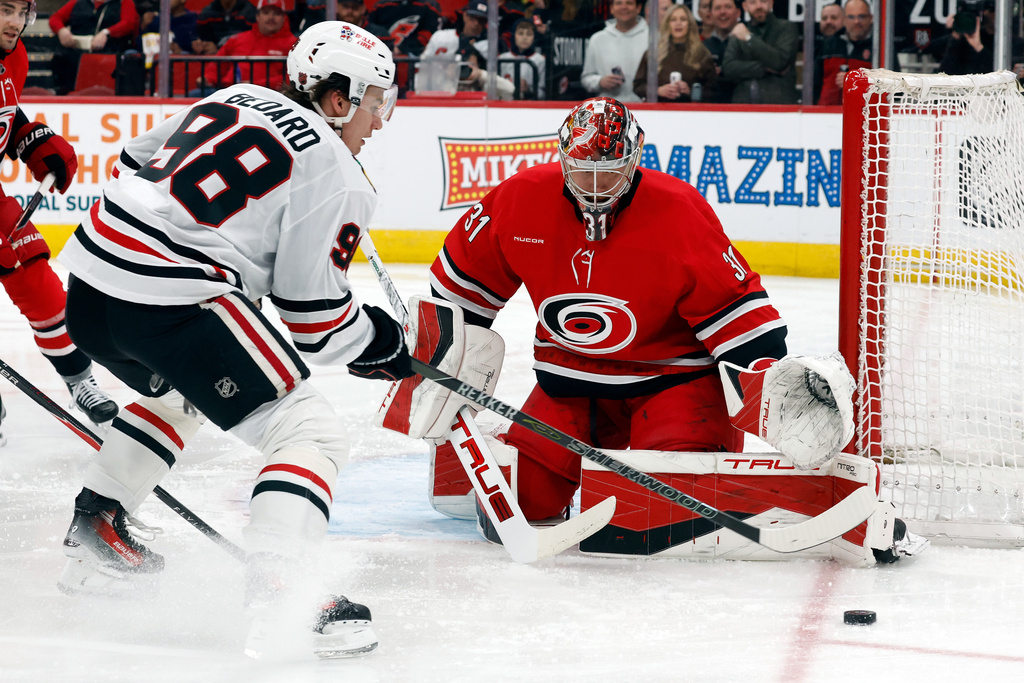 Chicago Blackhawks' Connor Bedard (98) looses control of the puck near Carolina Hurricanes goaltender Frederik Andersen during the first period of an NHL hockey game in Raleigh, N.C., Thursday, Jan. 22, 2026. (AP Photo/Karl DeBlaker)