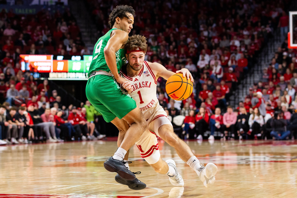 Nebraska guard Sam Hoiberg (1) drives the ball against North Dakota guard Anthony Smith III (9) during the first half of an NCAA college basketball game, Sunday, Dec. 21, 2025, in Lincoln, Neb. (AP Photo/Bonnie Ryan)