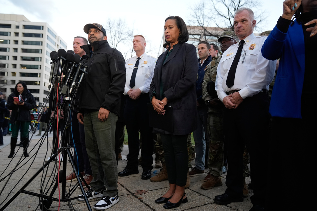 Flanked by District of Columbia Mayor Muriel Bowser, center, and Executive Assistant Chief, Metropolitan Police Department Jeffery Carroll, center left, FBI Director Kash Patel speaks during a press conference following the shooting of two National Guard soldiers near the White House Wednesday, Nov. 26, 2025, in Washington. (AP Photo/Mark Schiefelbein)