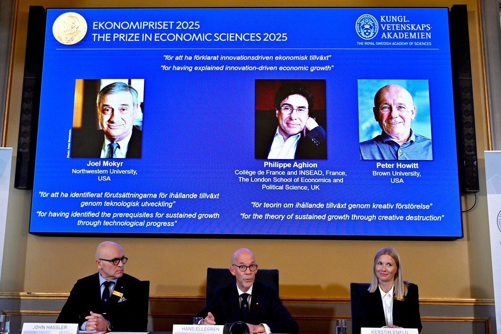 Professor John Hassler, from left, Hans Ellegren, Permanent Secretary of the Academy of Sciences and Professor Kerstin Enflo, announce Joel Mokyr, Philippe Aghion and Peter Howitt as the recipients of the Nobel Memorial Prize in Economics during a press conference at the Royal Swedish Academy of Sciences in Stockholm, Sweden, Monday, Oct. 13, 2025. (Anders Wiklund/TT News Agency via AP)