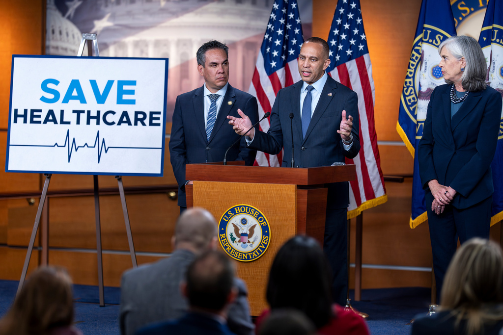 House Minority Leader Hakeem Jeffries, D-N.Y., flanked by Rep. Pete Aguilar, D-Calif., left, and Rep. Katherine Clark, D-Mass., speaks during a news conference on day 22 of the government shutdown to discuss its impact on health care, at the Capitol in Washington, Wednesday, Oct. 22, 2025. (AP Photo/J. Scott Applewhite)