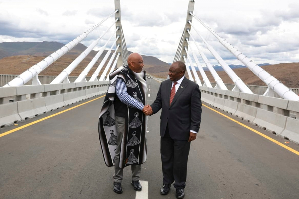 In this photo provided by the South African Government Communications and Information Services (GCIS), King of Lesotho Letsie III, left, shakes hand with South African President Cyril Ramaphosa following the official opening of the Senqu Bridge in Mokhotlong, Lesotho, Wednesday, April 22, 2026. (Elmond Jiyane/South African Government Communication and Information Services via AP)