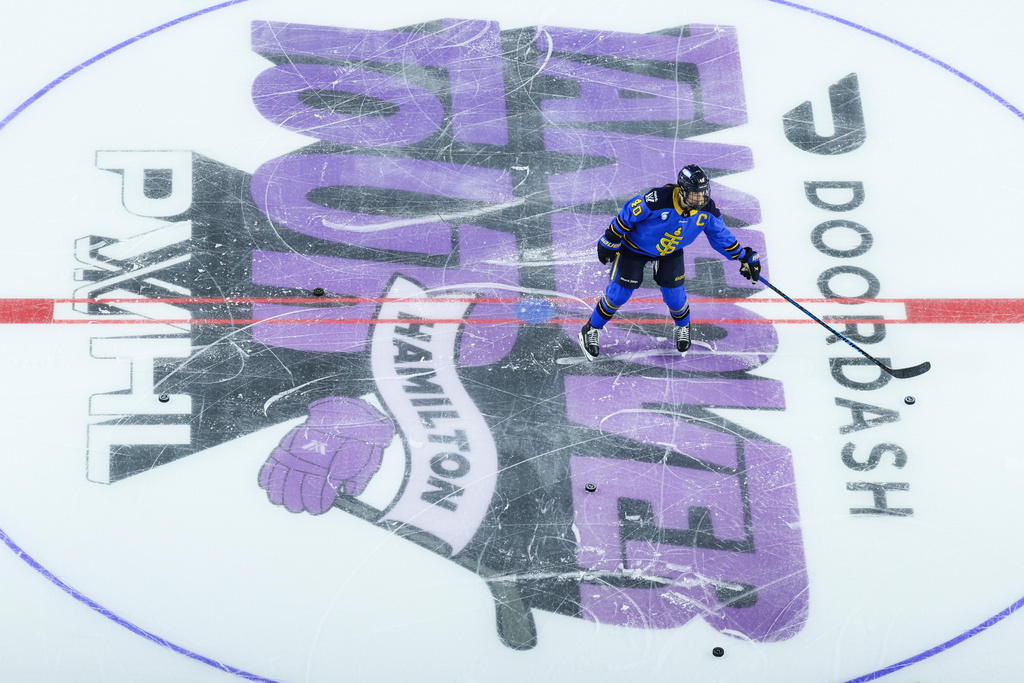 FILE - Toronto Sceptres' Blayre Turnbull (40) collects pucks on the PWHL Takeover Tour logo ahead of PWHL action against the Seattle Torrent in Hamilton, Ontario, Canada, on Saturday, Jan. 3, 2026. (Nick Iwanyshyn/The Canadian Press via AP, File)
