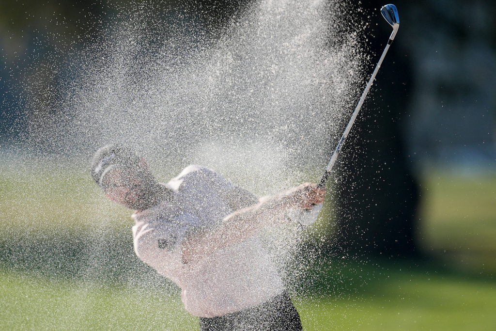 Patrick Rodgers hits from a bunker on the first hole during the first round of the RSM Classic golf tournament, Thursday, Nov. 20, 2025, in St. Simons Island, Ga. (AP Photo/Mike Stewart)