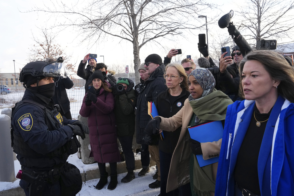 Rep. Kelly Morrison D-Minn., center, Rep. Ilhan Omar, D-Minn., second from the right, and Rep. Angie Craig, D-Minn., far right, at the Bishop Whipple Federal Building, Saturday, Jan. 10, 2026, in Minneapolis. (AP Photo/Adam Gray)
