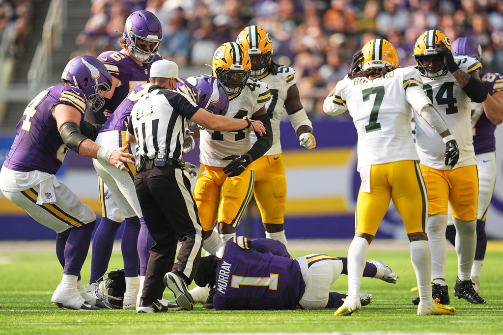 Minnesota Vikings and Green Bay Packers players look on after Vikings quarterback Kyler Murray was tackled during the first half of an NFL football game, Sunday, Sept. 13, 2026, in Minneapolis, Minn. (AP Photo/Abbie Parr)