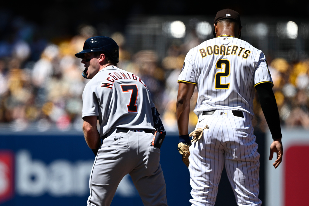 Detroit Tigers' Kevin McGonigle (7) celebrates after hitting an RBI double as San Diego Padres shortstop Xander Bogaerts (2) looks on during the first inning of an opening-day baseball game Thursday, March 26, 2026, in San Diego. (AP Photo/Denis Poroy) CORRECTS SPELLING OF McGonigle from McGonigal.