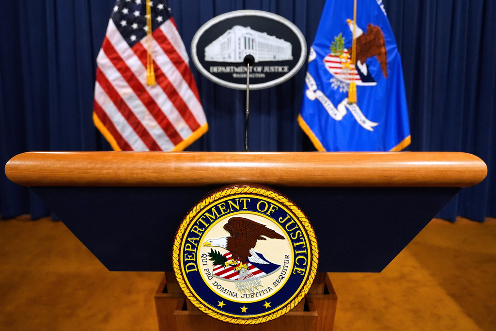FILE - The U.S. Department of Justice logo is seen on a podium before a press conference, May 6, 2025, at the Justice Department in Washington. (AP Photo/Julia Demaree Nikhinson, File)