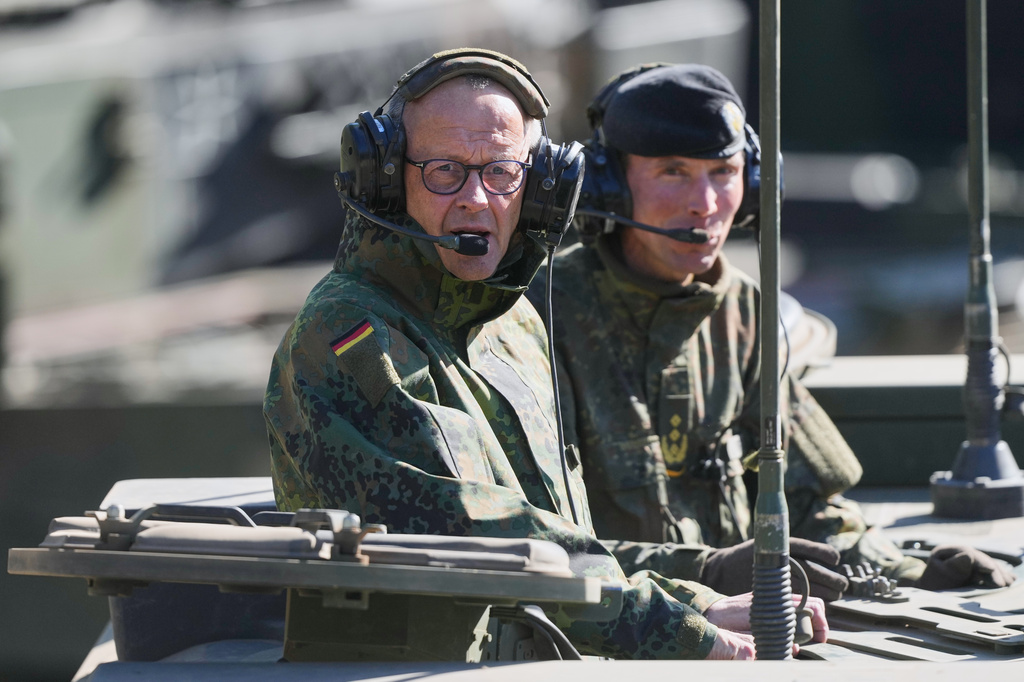 German Chancellor Friedrich Merz drives in the armoured fighting vehicle Boxer during his visit to the army at the Bundeswehr base in Munster, Germany, Thursday, April, 30, 2026. (AP Photo/Markus Schreiber, Pool)