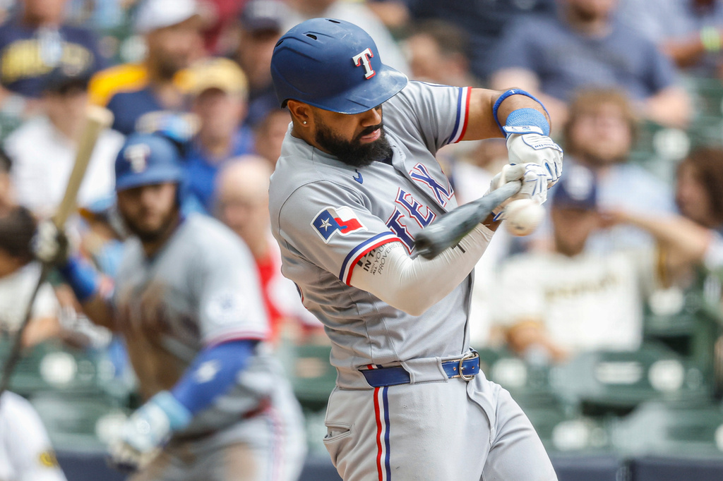 Texas Rangers' Ezequiel Duran hits a two-RBI double against the Milwaukee Brewers during the fifth inning of a baseball game Sunday, Aug. 30, 2026, in Milwaukee. (AP Photo/Jeffrey Phelps)