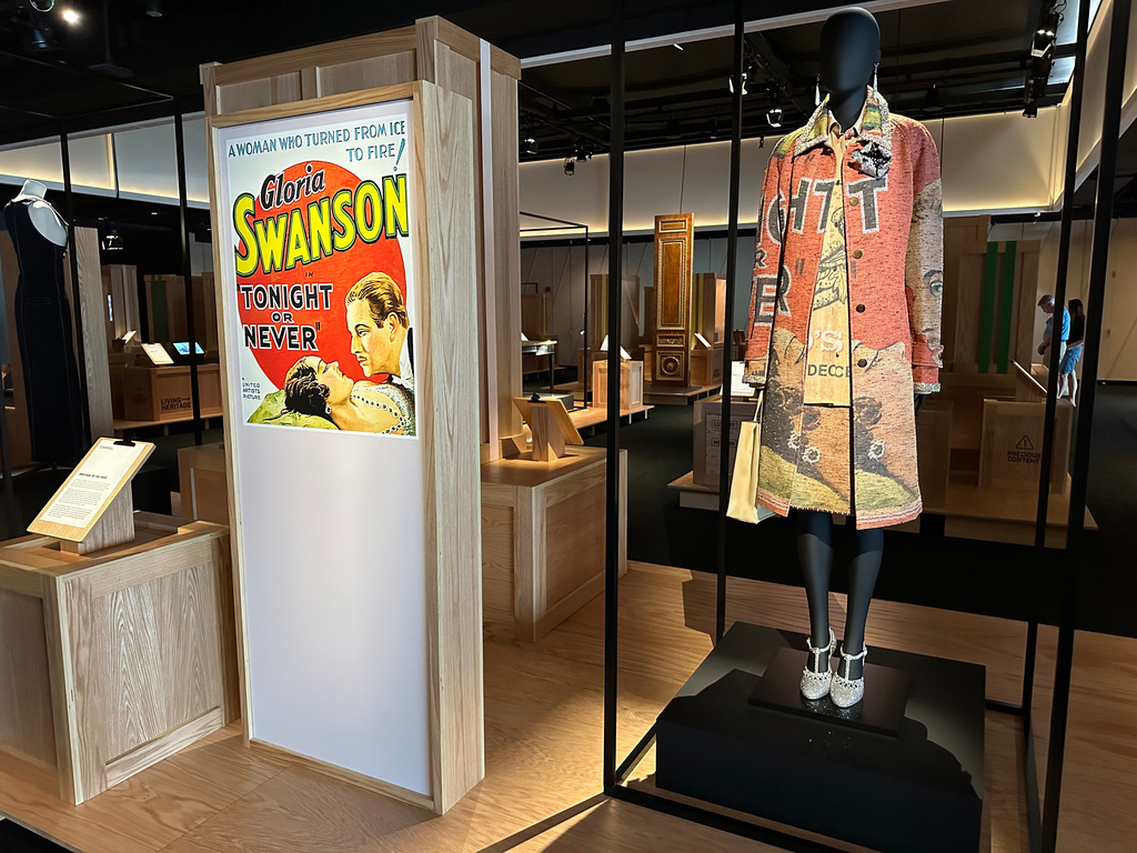 A Chanel coat and midi skirt inspired by the poster for the 1931 film "Tonight or Never" is pictured on display as part of the Comite Colbert "Hidden Treasures" exhibit at The Shed on Tuesday, May 26, 2026, in New York. (AP Photo/Beatrice Dupuy)