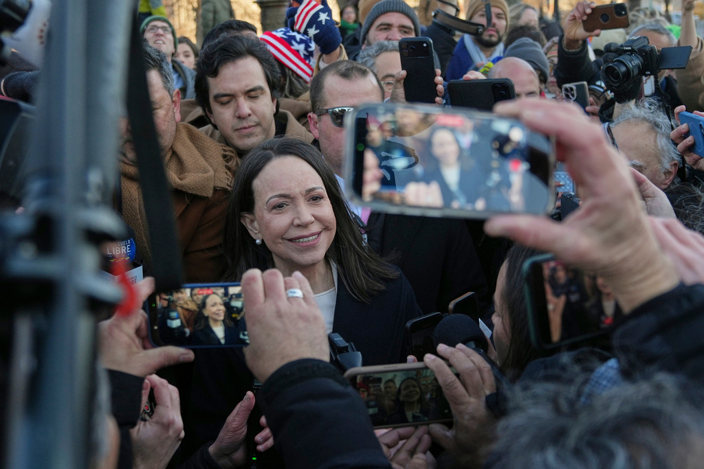 Venezuelan opposition leader María Corina Machado, center, leaves the Capitol, Thursday, Jan. 15, 2026, in Washington. (AP Photo/Allison Robbert)