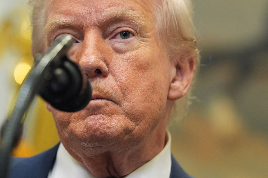 President Donald Trump listens to a question from a reporter during an event with Environmental Protection Agency director Lee Zeldin to announce the EPA will no longer regulate greenhouse gases, in the Roosevelt Room of the White House, Thursday, Feb. 12, 2026, in Washington. (AP Photo/Evan Vucci)